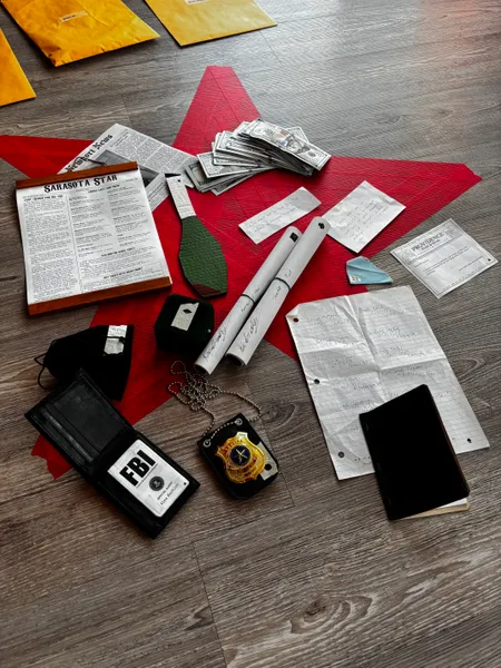 Circus themed props, including newspapers, badges, money, and notes
