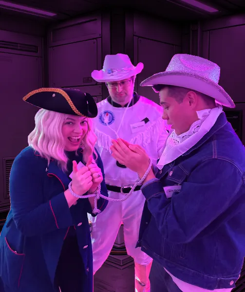 A pair of space cowboys are happily arrested by an astronaut